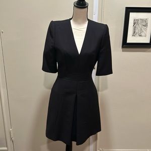 Alexander McQueen black fit and flare dress with side pockets deep V-neck line